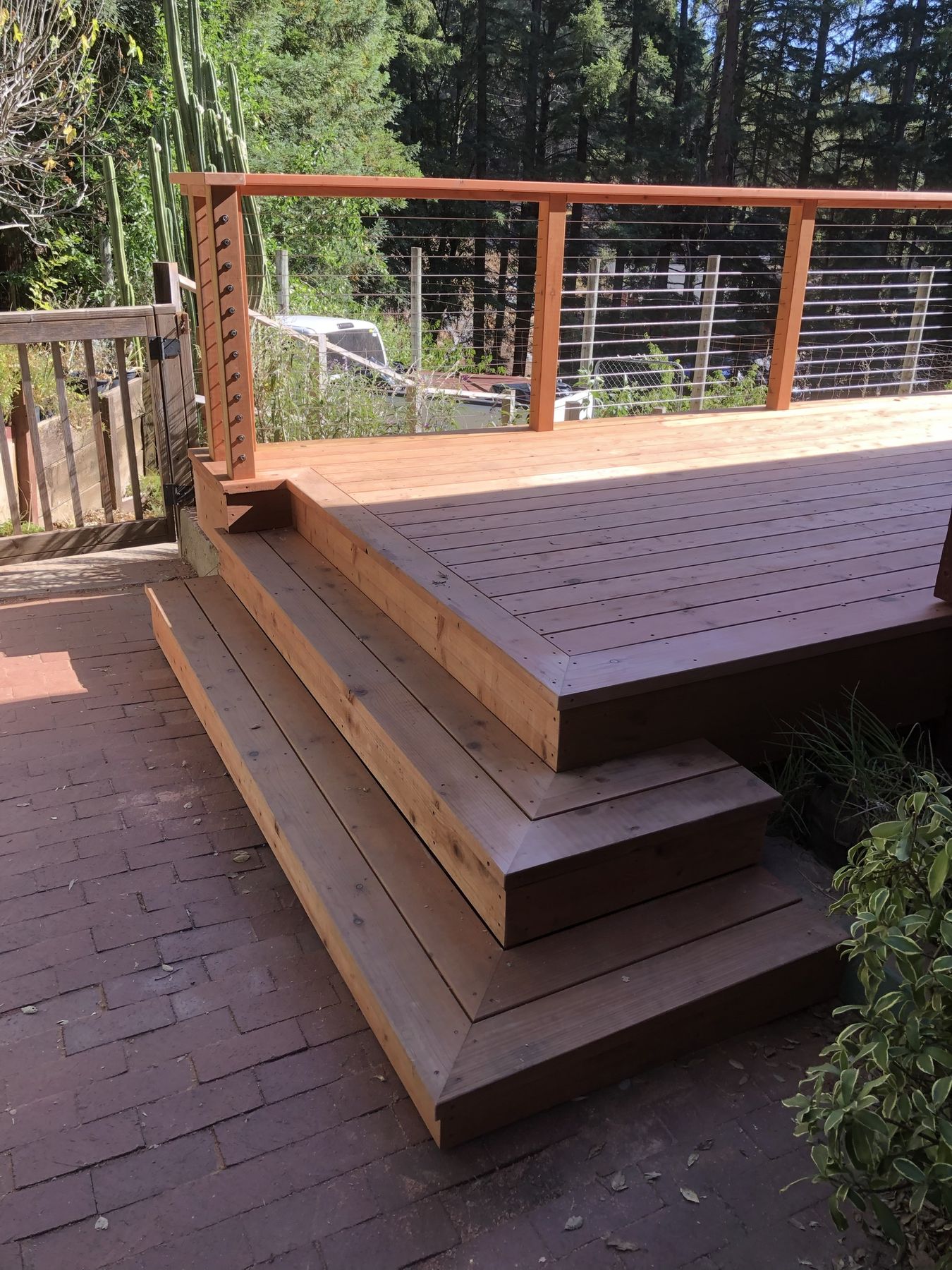 Redwood deck with picture-frame border, wrap stairs and cable railing