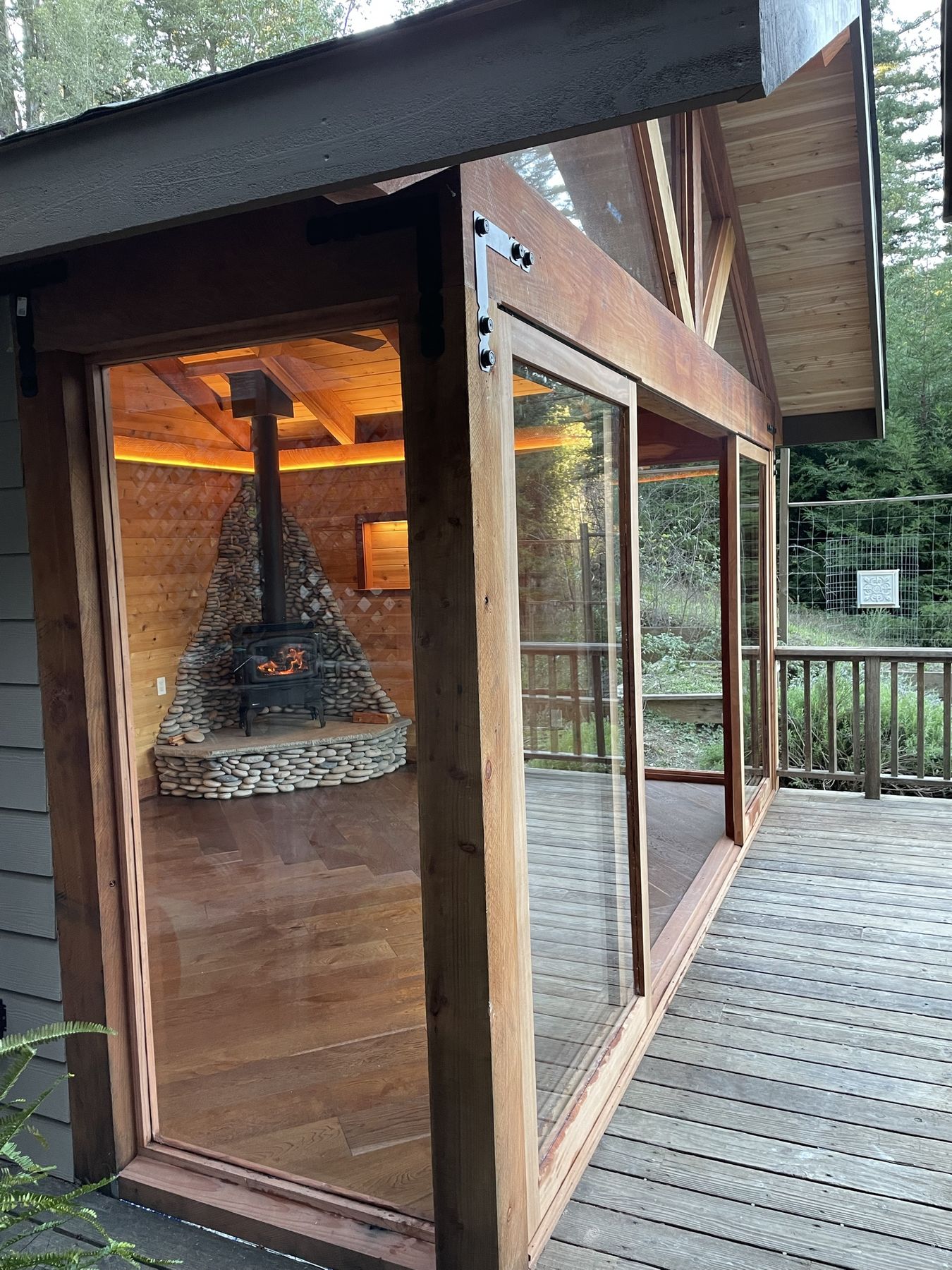 Side view of glass-walled studio with warm lighting